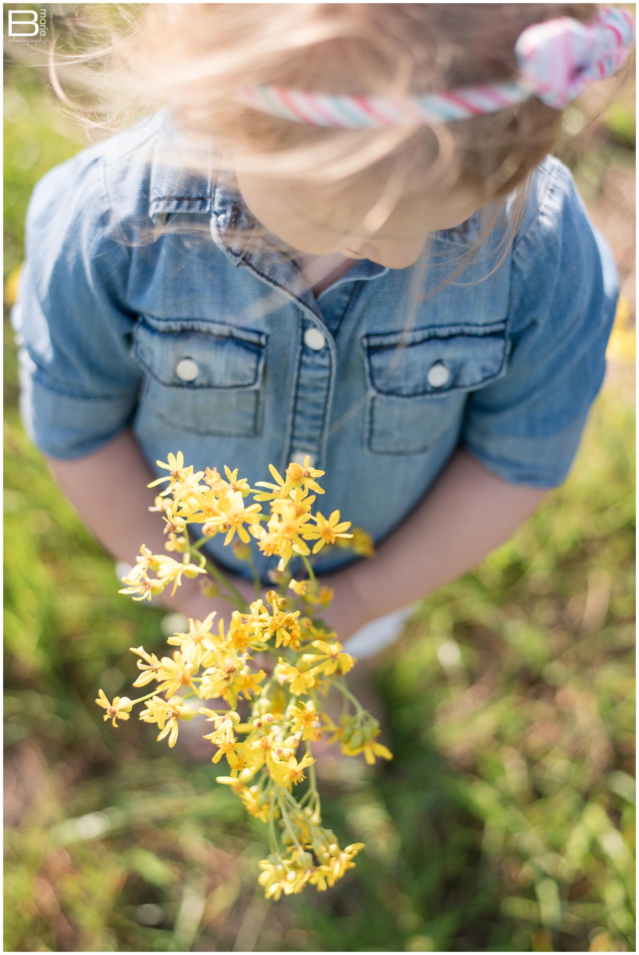 Kingwood family photographer image of toddler with picked wildflowers