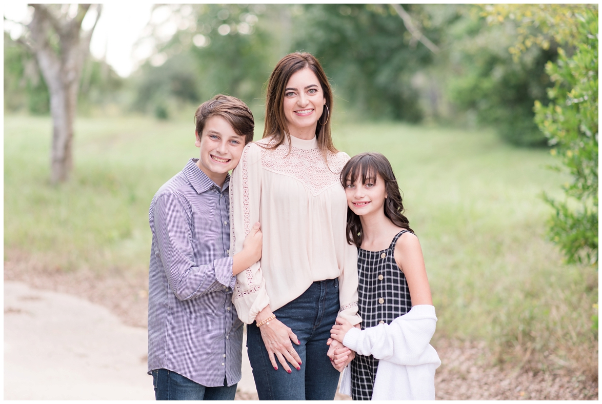 Kingwood family photographer mini session with family of three in natural, outdoor setting with yellow wildflowers